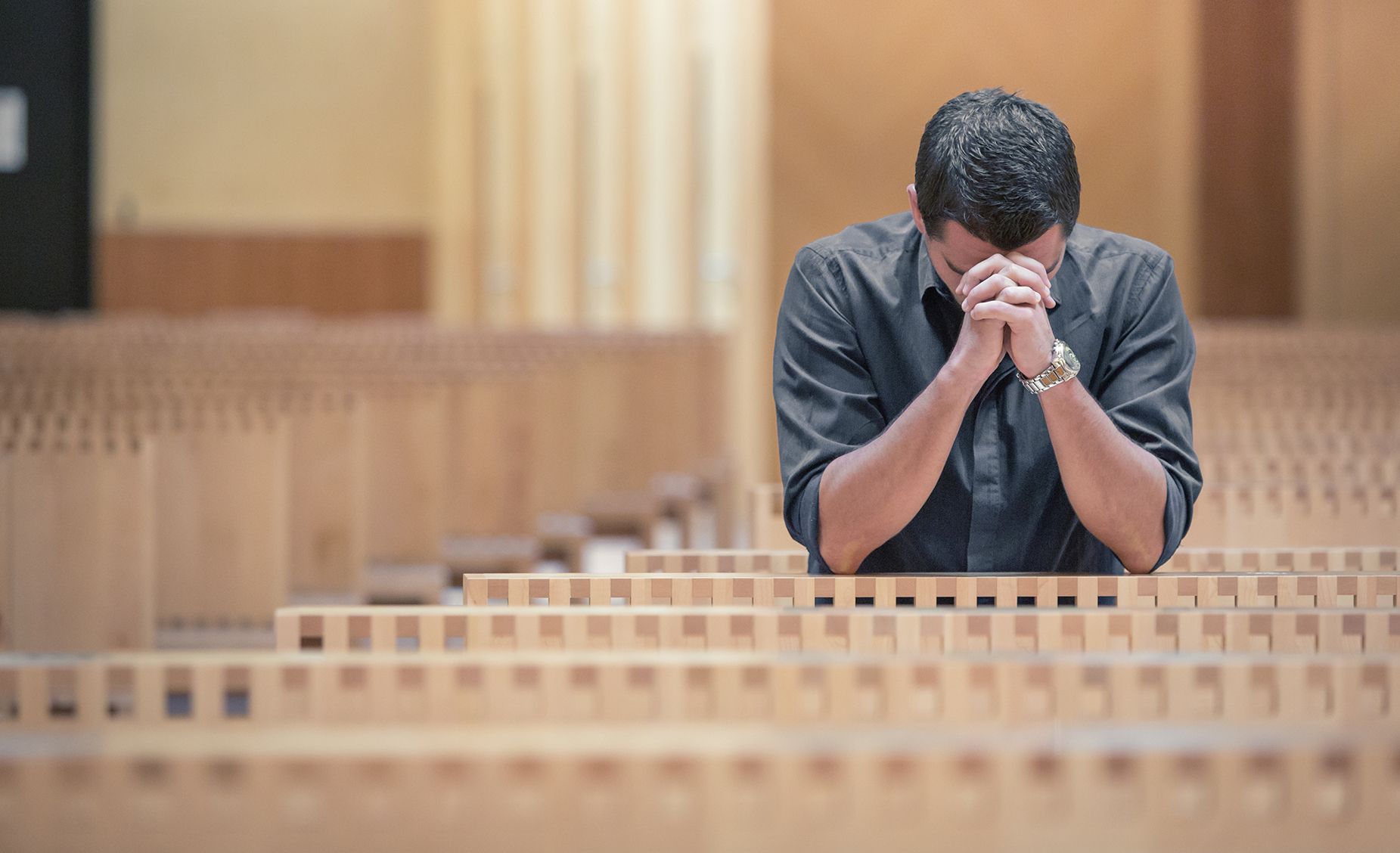 man praying in church